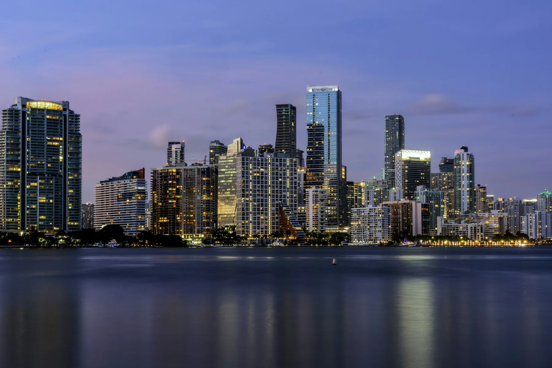 The Miami skyline illuminated along the bay at dusk